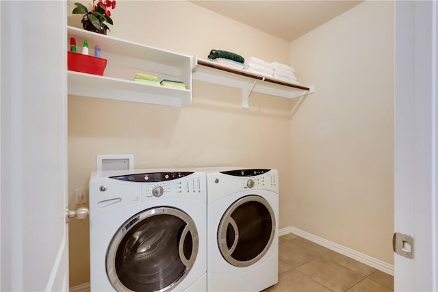 2002 S Ash Cv, Hutto, TX 78634 - laundry room with washing machine and clothes dryer, baseboards, and light tile patterned floors