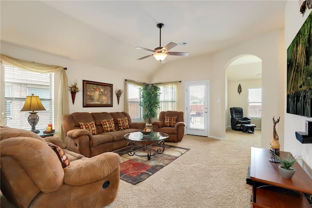 2002 S Ash Cv, Hutto, TX 78634 - carpeted living room featuring arched walkways, ceiling fan, and healthy amount of natural light