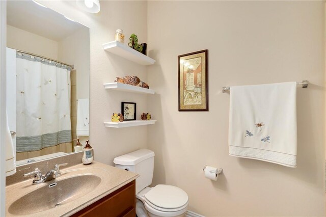 2002 S Ash Cv, Hutto, TX 78634 - full bath with toilet, vanity, and a shower with shower curtain