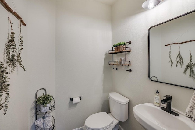 7709 Menchaca Rd Unit 16, Austin, TX 78745 - half bath featuring toilet, a sink, and baseboards