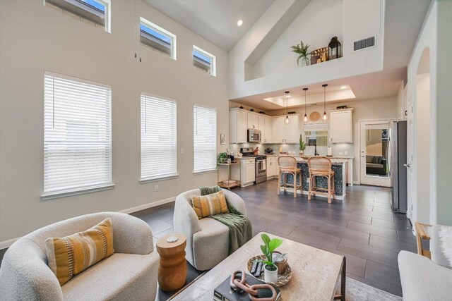 7709 Menchaca Rd Unit 16, Austin, TX 78745 - living area featuring a towering ceiling, recessed lighting, baseboards, and dark tile patterned flooring