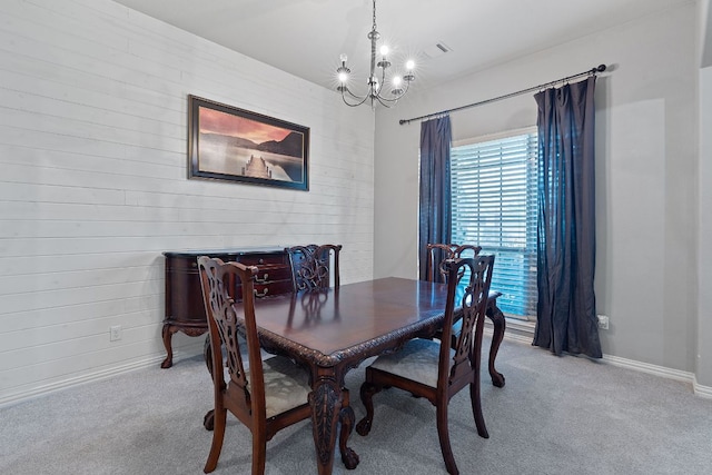 3217 Falconers Way, Pflugerville, TX 78660 - carpeted dining space featuring a chandelier, baseboards, and wood walls