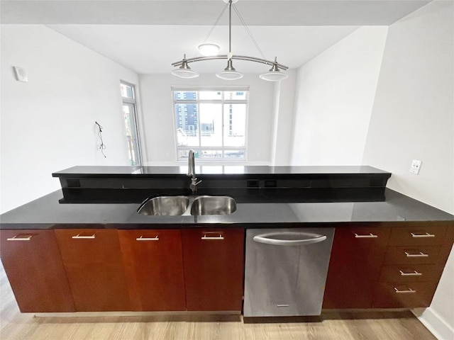 603 Davis St Unit 1108, Austin, TX 78701 - kitchen featuring a sink, dark countertops, light wood finished floors, and stainless steel dishwasher