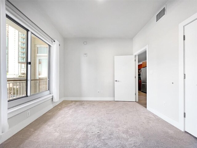 603 Davis St Unit 1108, Austin, TX 78701 - carpeted spare room featuring baseboards