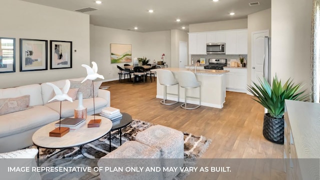 13700 Bothwell Pl, Manor, TX 78653 - living area featuring light wood-style flooring and recessed lighting