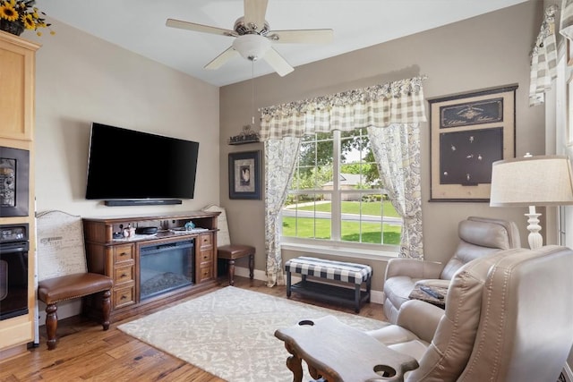 115 Durango Trl, Georgetown, TX 78633 - living room featuring light wood-style flooring, a ceiling fan, and baseboards