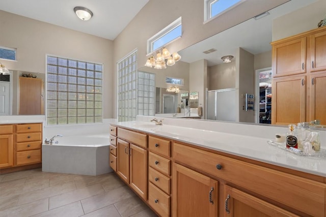115 Durango Trl, Georgetown, TX 78633 - bathroom featuring vanity, a shower stall, a bath, tile patterned floors, and a chandelier