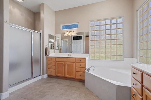 115 Durango Trl, Georgetown, TX 78633 - bathroom with vanity, a stall shower, a bath, a chandelier, and tile patterned floors