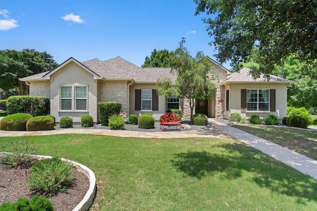 115 Durango Trl, Georgetown, TX 78633 - ranch-style home with stone siding, stucco siding, a front lawn, and a shingled roof