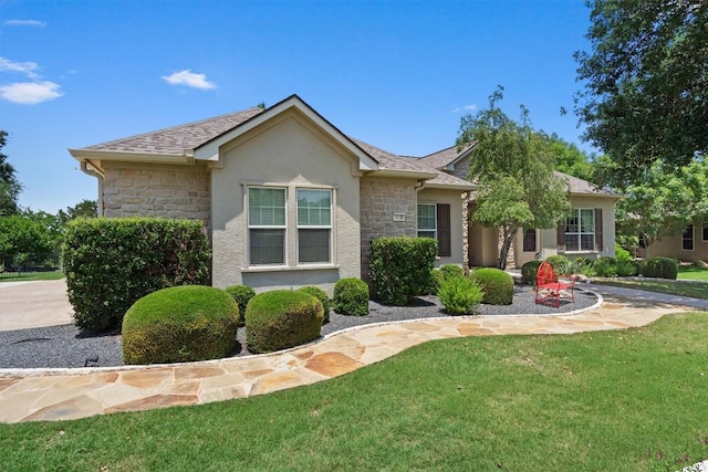 115 Durango Trl, Georgetown, TX 78633 - view of front facade with stone siding, stucco siding, and a front yard