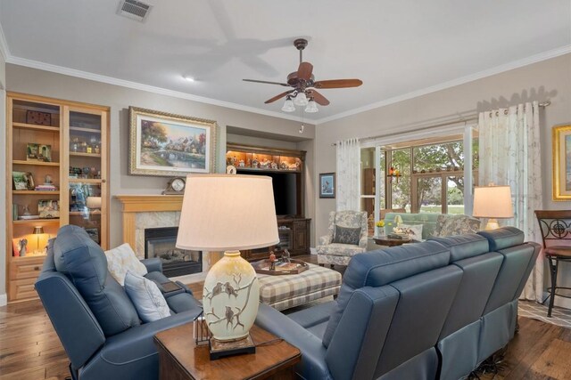 115 Durango Trl, Georgetown, TX 78633 - living room with a ceiling fan, ornamental molding, wood finished floors, and a fireplace