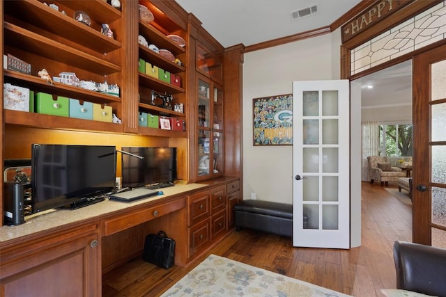 115 Durango Trl, Georgetown, TX 78633 - office featuring crown molding, french doors, built in study area, and dark wood-type flooring
