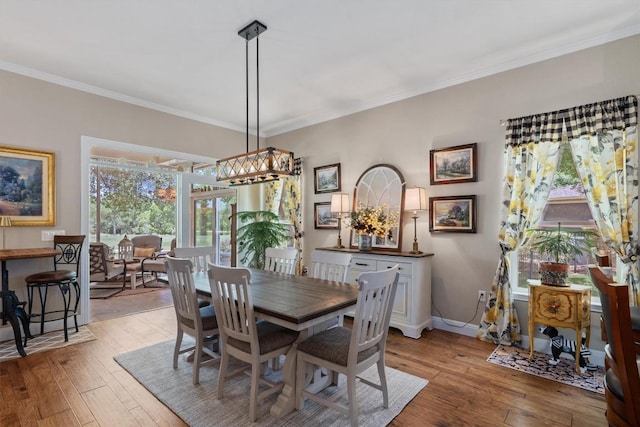 115 Durango Trl, Georgetown, TX 78633 - dining area featuring light wood-type flooring, crown molding, and baseboards