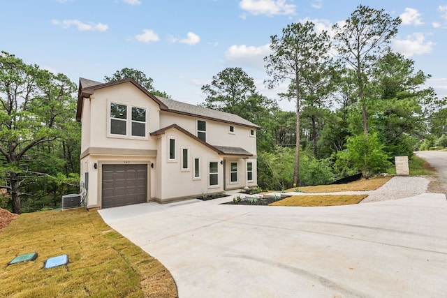 182 Kaanapali Ln, Bastrop, TX 78602 - view of front of property with stucco siding, concrete driveway, an attached garage, and roof with shingles