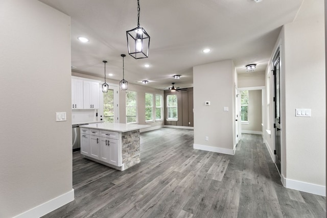 182 Kaanapali Ln, Bastrop, TX 78602 - kitchen with open floor plan, recessed lighting, white cabinetry, light countertops, and wood finished floors