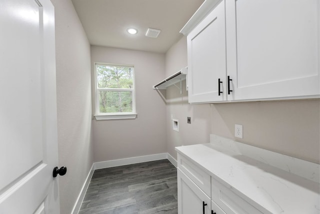 182 Kaanapali Ln, Bastrop, TX 78602 - laundry room featuring electric dryer hookup, cabinet space, dark wood finished floors, washer hookup, and recessed lighting