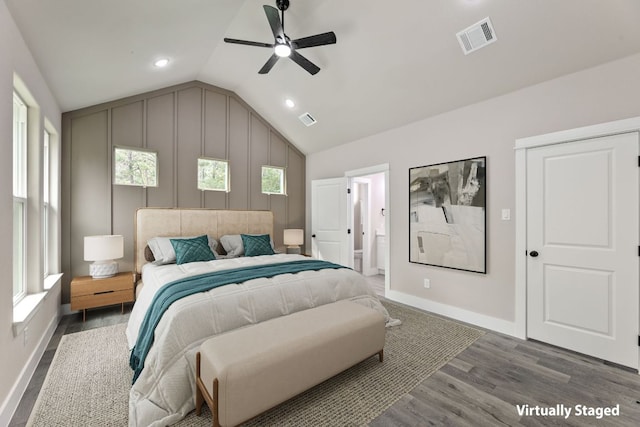 182 Kaanapali Ln, Bastrop, TX 78602 - bedroom featuring vaulted ceiling, wood finished floors, multiple windows, recessed lighting, and ensuite bathroom
