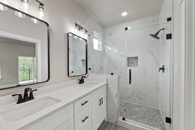 182 Kaanapali Ln, Bastrop, TX 78602 - bathroom featuring a marble finish shower, double vanity, and recessed lighting