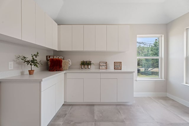 100 Toltec Cv, Kyle, TX 78640 - kitchen featuring light countertops, white cabinetry, baseboards, and modern cabinets