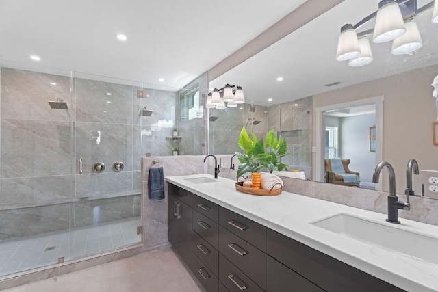 100 Toltec Cv, Kyle, TX 78640 - full bathroom featuring double vanity, a shower stall, recessed lighting, tile patterned floors, and ensuite bath