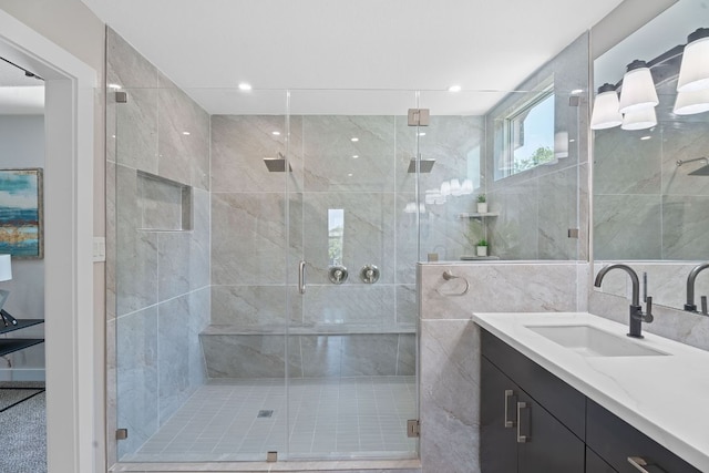 100 Toltec Cv, Kyle, TX 78640 - bathroom with vanity, a stall shower, and tile walls