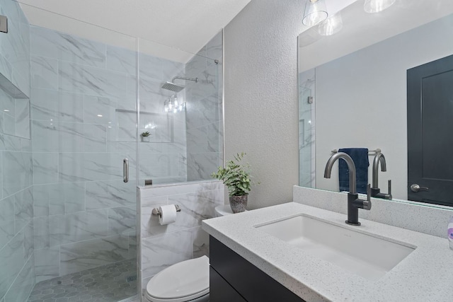 100 Toltec Cv, Kyle, TX 78640 - bathroom featuring toilet, vanity, a shower stall, and a textured wall