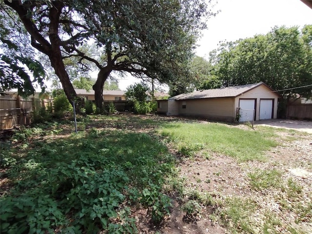 405 Oertli Ln, Austin, TX 78753 - view of yard featuring a detached garage and an outdoor structure