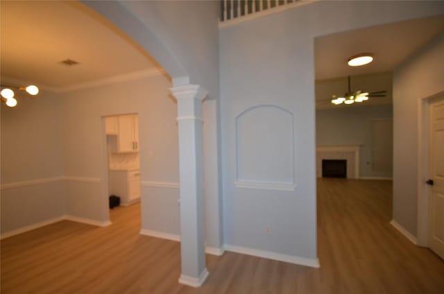 840 Smoke Signal Pass, Pflugerville, TX 78660 - hall featuring light wood-type flooring, a chandelier, arched walkways, baseboards, and crown molding
