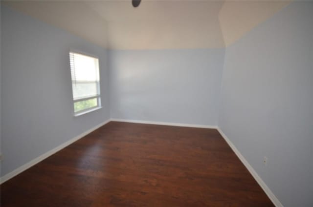 840 Smoke Signal Pass, Pflugerville, TX 78660 - empty room featuring wood finished floors, vaulted ceiling, and baseboards