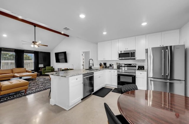 249 Hill Dr, Granite Shoals, TX 78654 - kitchen with appliances with stainless steel finishes, a sink, a peninsula, white cabinets, and a ceiling fan