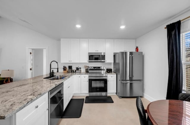 249 Hill Dr, Granite Shoals, TX 78654 - kitchen featuring appliances with stainless steel finishes, a sink, a peninsula, white cabinetry, and recessed lighting