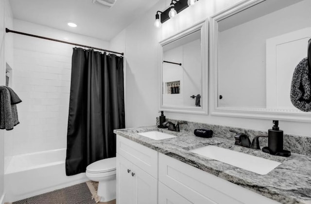 249 Hill Dr, Granite Shoals, TX 78654 - bathroom with toilet, double vanity, shower / bath combo with shower curtain, tile patterned floors, and recessed lighting