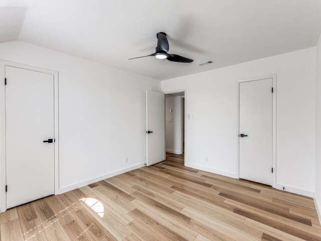 7920 Rockwood Ln Unit 208, Austin, TX 78757 - unfurnished bedroom featuring light wood-type flooring, a ceiling fan, and baseboards