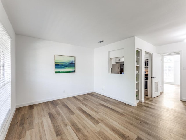 7920 Rockwood Ln Unit 208, Austin, TX 78757 - empty room with light wood-style flooring and baseboards
