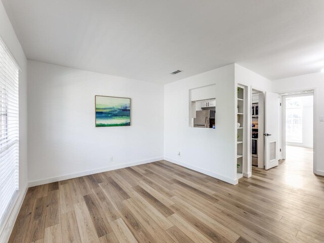 7920 Rockwood Ln Unit 208, Austin, TX 78757 - unfurnished room with light wood-type flooring and baseboards