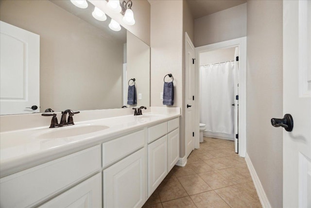 613 Horseback Holw, Austin, TX 78732 - full bath featuring toilet, double vanity, tile patterned floors, baseboards, and curtained shower