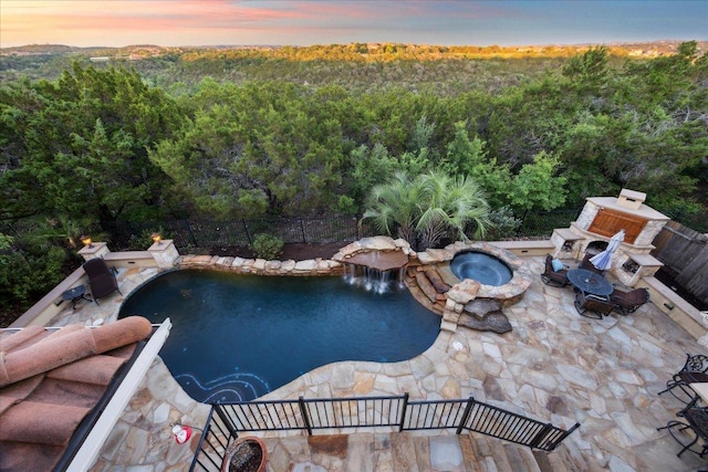 613 Horseback Holw, Austin, TX 78732 - pool at dusk with an outdoor fire pit, a forest view, and a patio