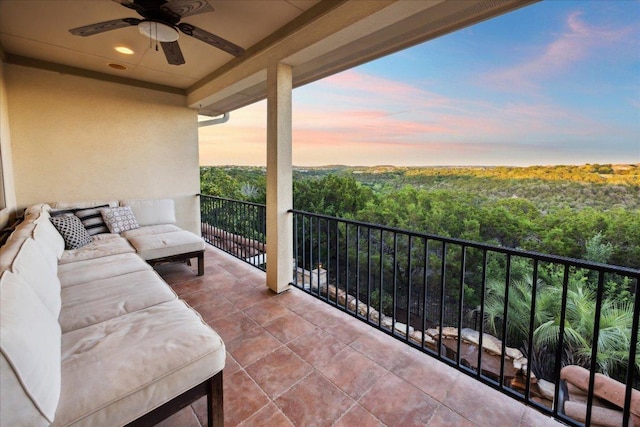 613 Horseback Holw, Austin, TX 78732 - balcony at dusk featuring ceiling fan, a forest view, and an outdoor living space