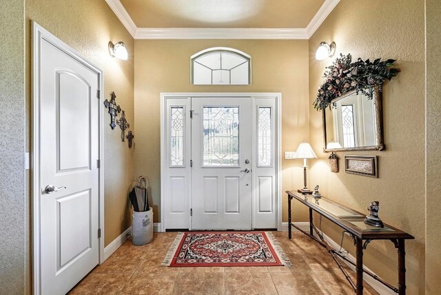217 Circle Oaks Dr, Burnet, TX 78611 - tiled entrance foyer featuring crown molding, healthy amount of natural light, baseboards, and a textured wall