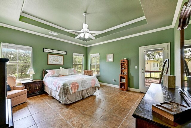 217 Circle Oaks Dr, Burnet, TX 78611 - tiled bedroom featuring a raised ceiling, access to exterior, crown molding, baseboards, and ceiling fan