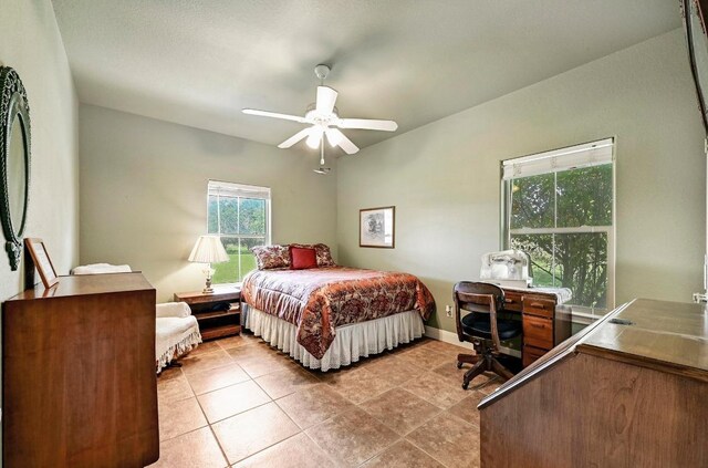 217 Circle Oaks Dr, Burnet, TX 78611 - bedroom with a desk, light tile patterned floors, baseboards, and a ceiling fan