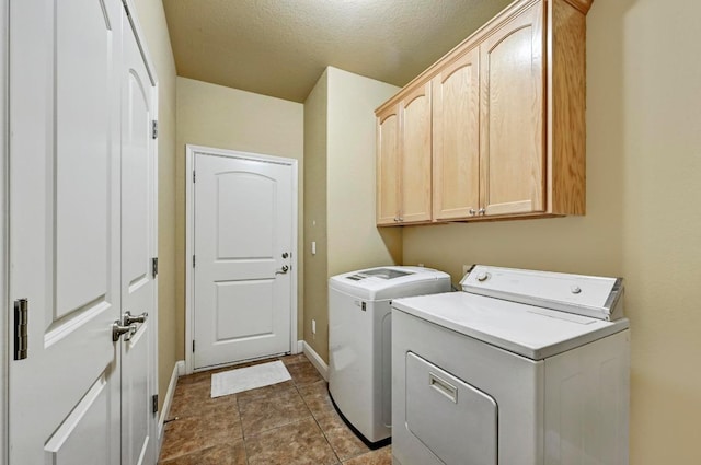 217 Circle Oaks Dr, Burnet, TX 78611 - washroom with cabinet space, washer and dryer, baseboards, and a textured ceiling