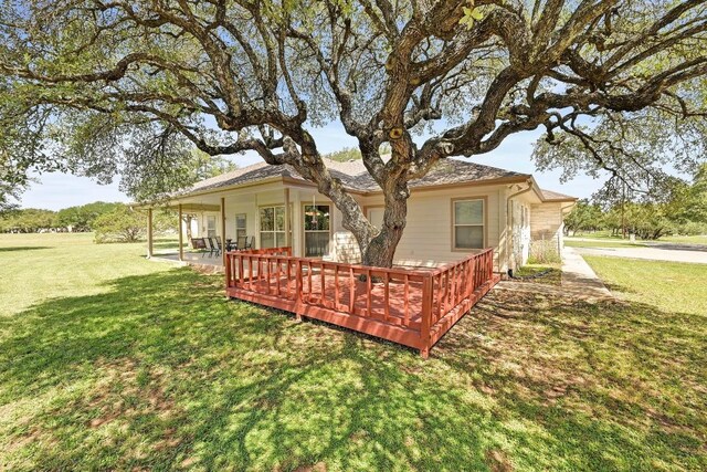 217 Circle Oaks Dr, Burnet, TX 78611 - back of property featuring a lawn