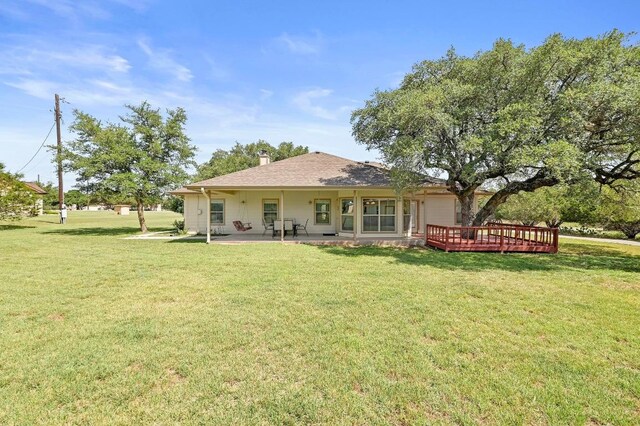 217 Circle Oaks Dr, Burnet, TX 78611 - back of house with a lawn, a patio, a chimney, and a wooden deck