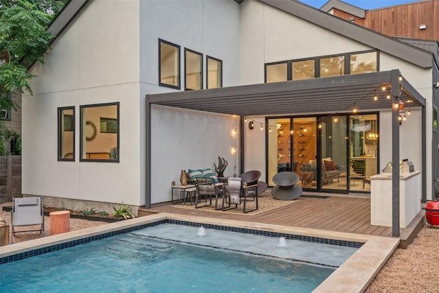 2010 Oxford Ave, Austin, TX 78704 - back of house with a deck, an outdoor pool, and stucco siding