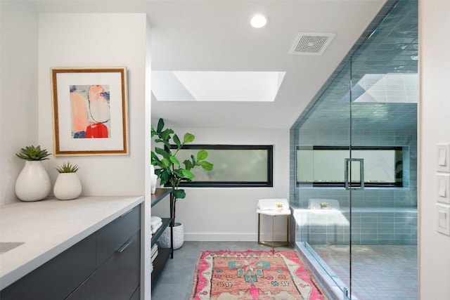 2010 Oxford Ave, Austin, TX 78704 - bathroom with a skylight, vanity, concrete flooring, a stall shower, and recessed lighting