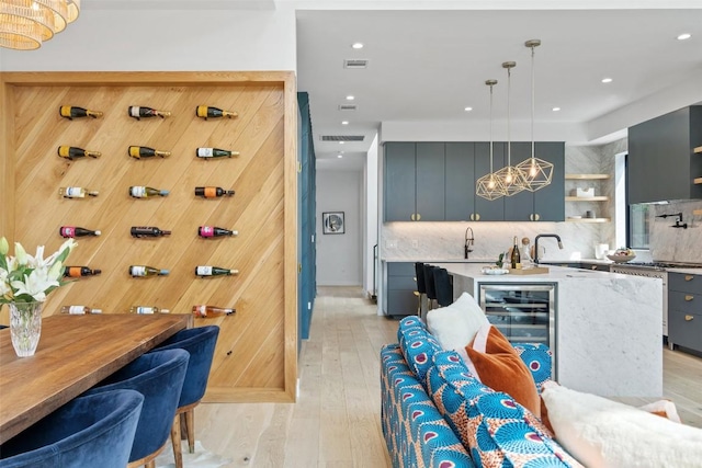 2010 Oxford Ave, Austin, TX 78704 - kitchen featuring wine cooler, decorative backsplash, open shelves, light wood-style flooring, and recessed lighting