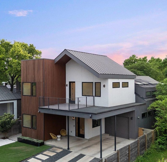 2010 Oxford Ave, Austin, TX 78704 - view of front of house with a balcony, a patio area, metal roof, and a standing seam roof