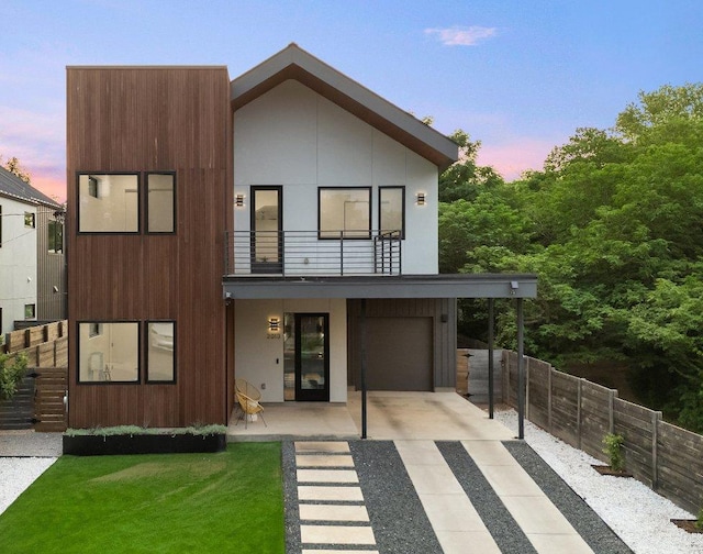2010 Oxford Ave, Austin, TX 78704 - modern home featuring a balcony, concrete driveway, and an attached garage