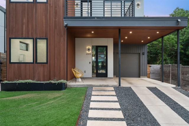 2010 Oxford Ave, Austin, TX 78704 - view of exterior entry with a balcony, driveway, and a garage